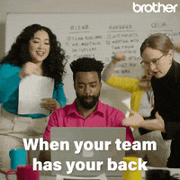 A team of coworkers celebrating, with a man sitting behind a laptop, looking happy, while three women cheer: one claps, another jumps in the air shouting 'hooray,' and the third dances excitedly. The text 'when your team has your back' is written over the image.