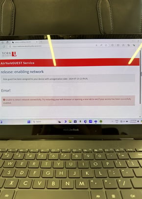 A picture of a laptop screen with keypad reflecting technology issues at York University website