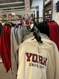 A York University sweatshirt on display at the York Bookstore in York Lanes, featuring the university's name and emblem.