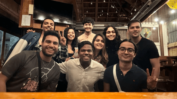 A group of friends posing for a picture at a pub.