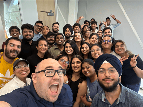 Students taking a selfie together with professor.
