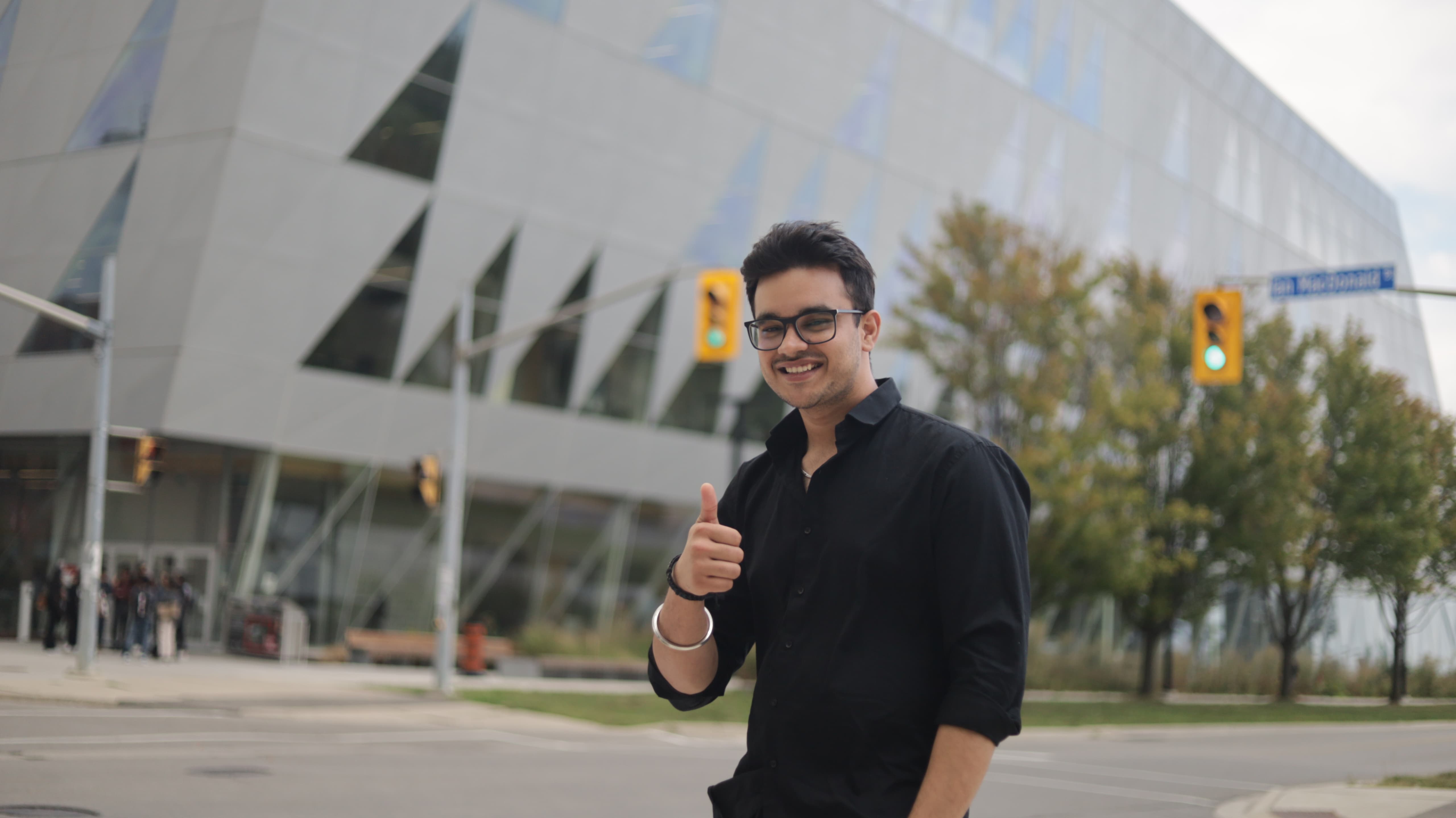York SCS student in front of York SCS building in Toronto