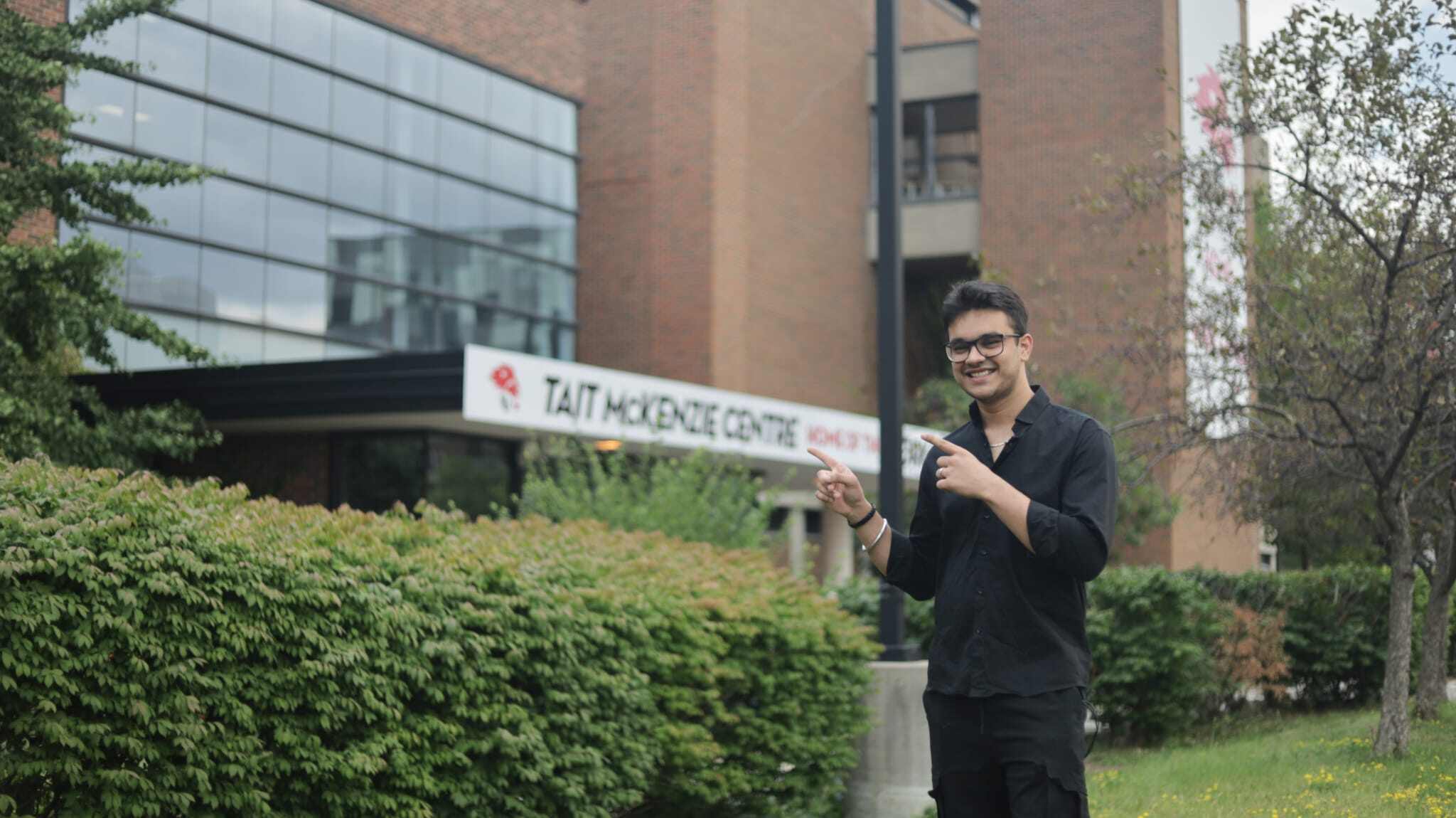 York SCS student in front of Tait Mckenzie Student Centre, York University