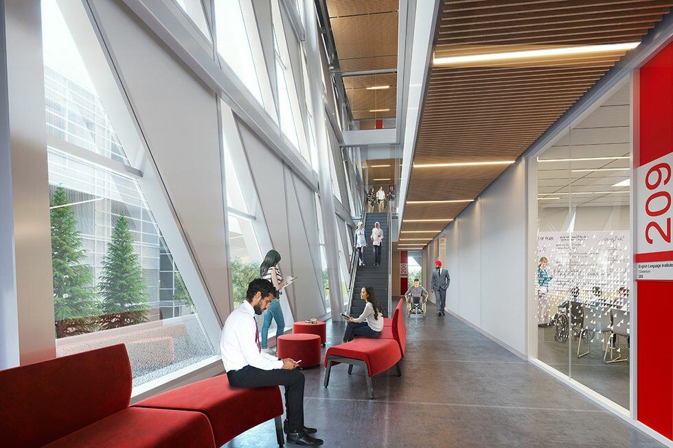 The inside of the York SCS building with students in the background sitting on sofa and walking forward