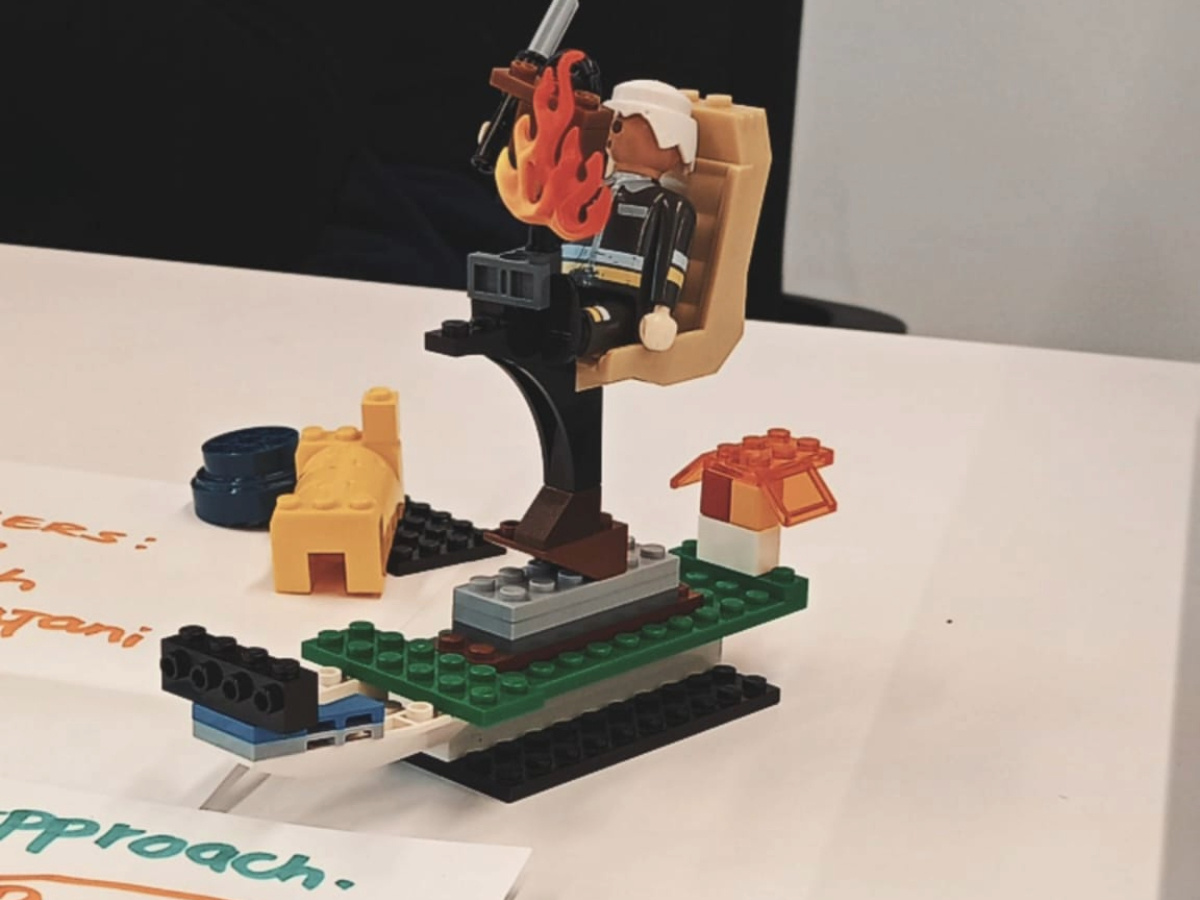 A man riding a space ship made out of lego set.