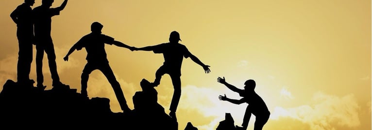 People helping each other for climbing the mountain 