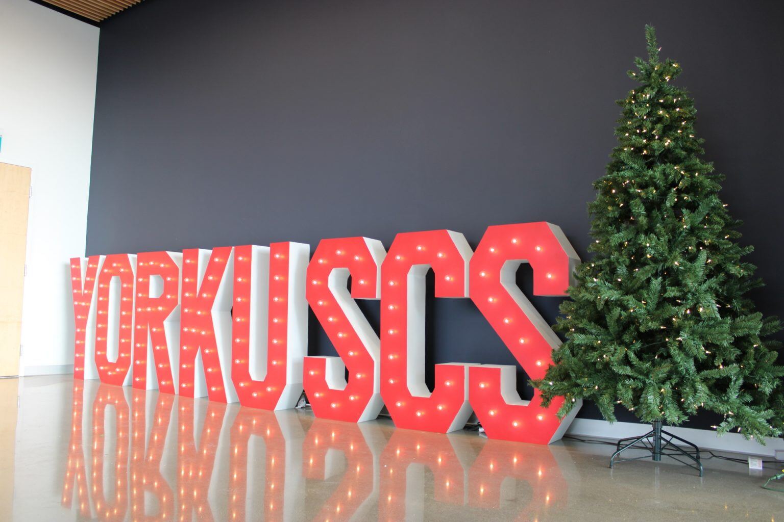YorkU SCS signage with a Christmas tree in the right side of the frame