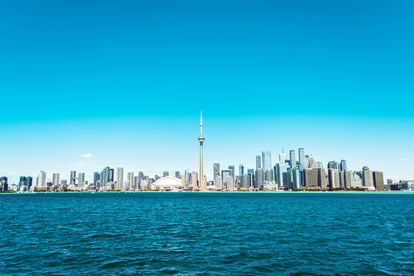 CN tower and building surrounding it from across the lake ontario