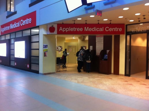  The entrance to the Appletree Medical Centre in York Lanes. There is a glass entryway with people inside the lobby area.