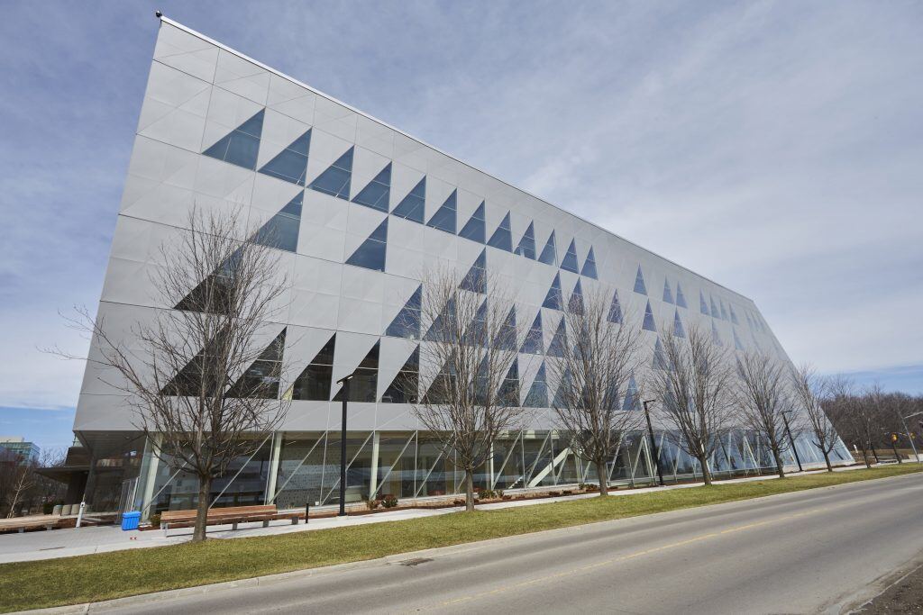 York SCS building with modern architecture, surrounded by bare trees and a clear road on a bright day.